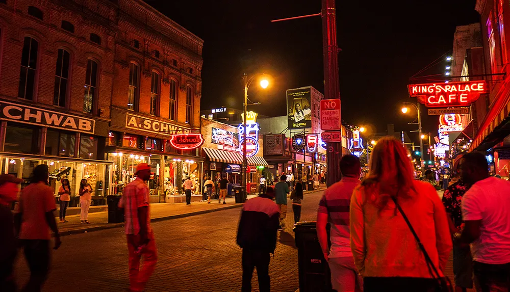 The image captures a vibrant night scene on a busy street lined with neon signs and people walking suggesting a lively urban nightlife atmosphere