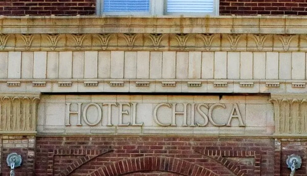 The image shows the ornate stone facade of the Hotel Chisca with its name prominently engraved in the architecture