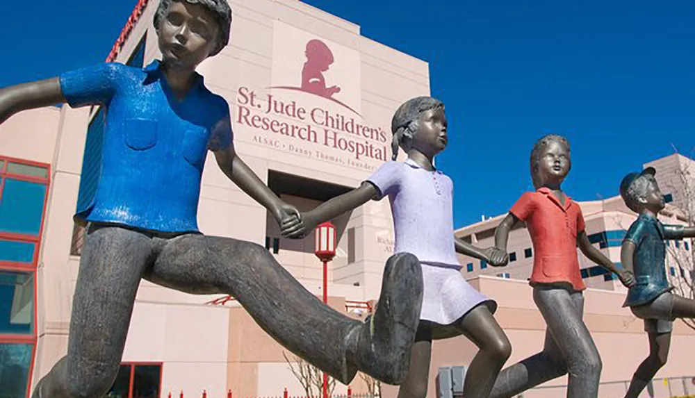 Sculptures of children holding hands and running in front of the St Jude Childrens Research Hospital building