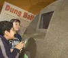 Several people including young visitors are observing the skeletal remains of a prehistoric creature on display in a museum exhibit