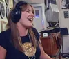 A person is joyfully jumping in front of Sun Studio which is known as the birthplace of rocknroll with a large guitar sign above