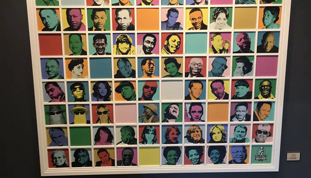 The image shows a large collage of colorful pop art-style portraits against a wall each featuring a different individual against a vibrant background