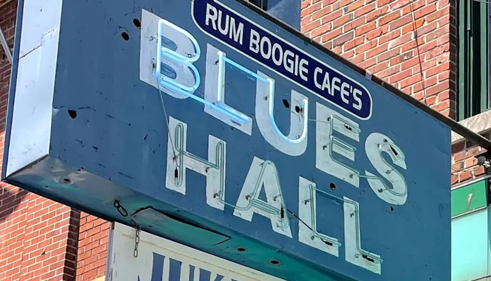 The image shows a worn sign for Rum Boogie Cafes Blues Hall likely indicating a venue known for blues music