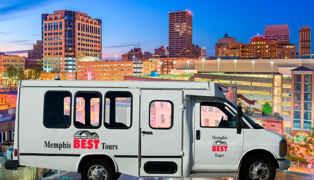 A tour van with Memphis BEST Tours on its side is parked with a backdrop of the Memphis skyline at twilight