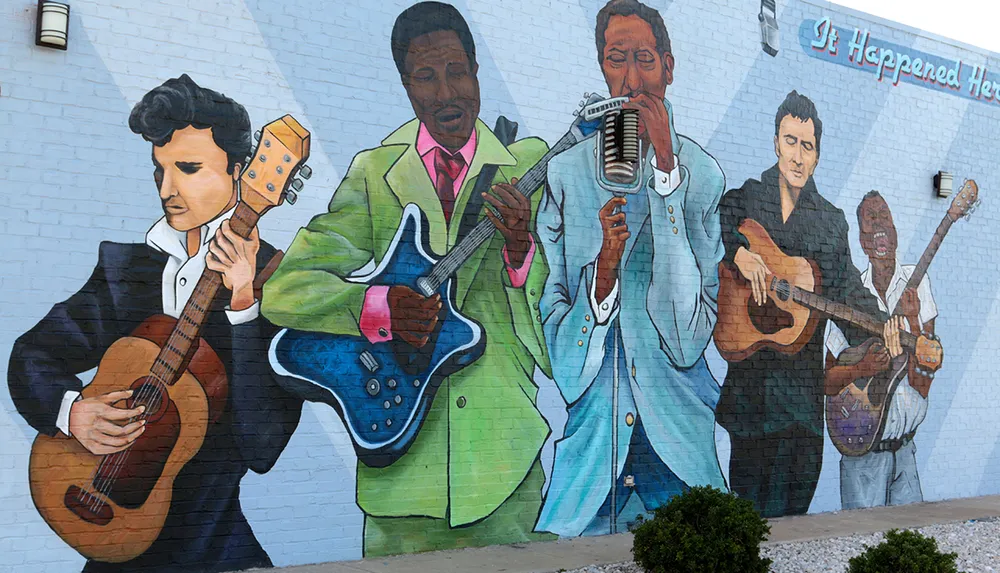 This image shows a colorful mural on a wall depicting a group of musicians with varied instruments including guitars and a harmonica with the phrase It Happened Here in the upper right corner