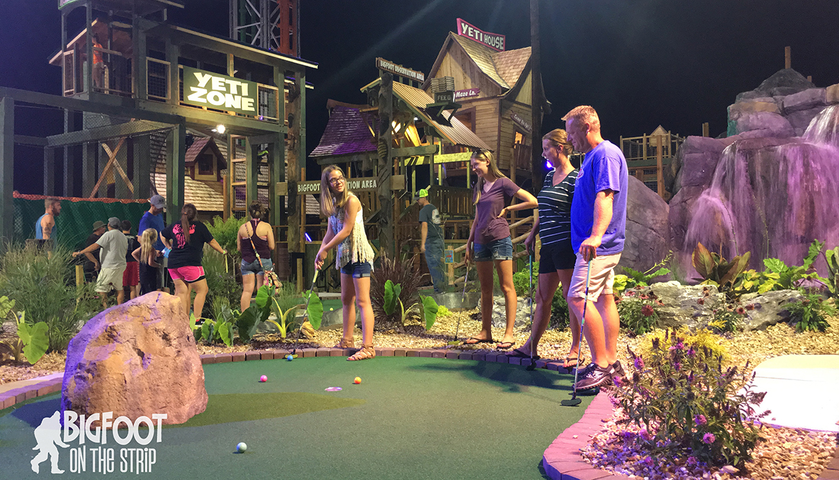 Family Playing Mini Golf